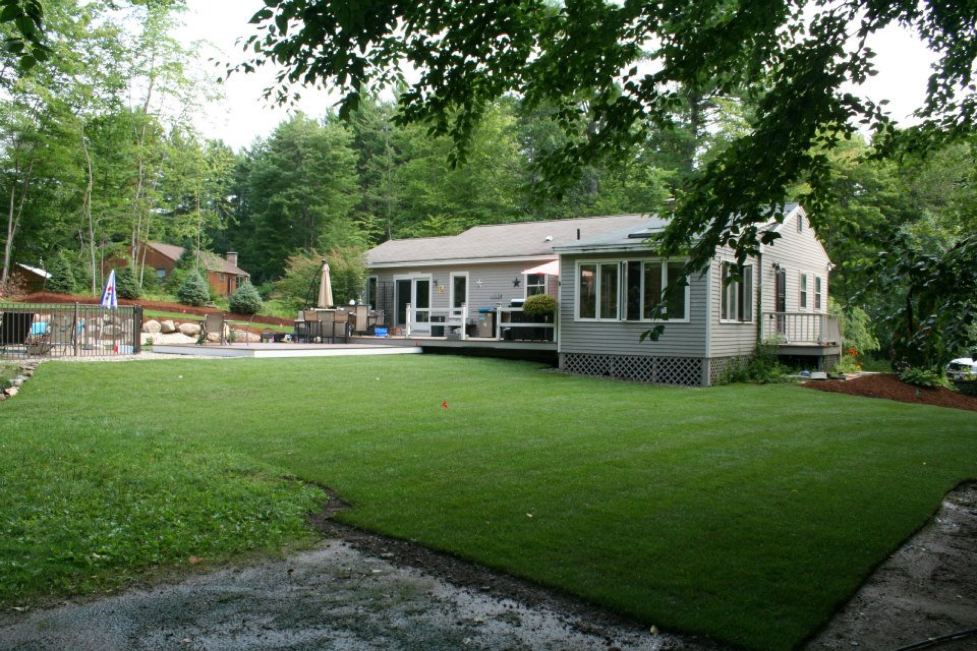 Property after a complete fall cleanup with clean beds and lawn